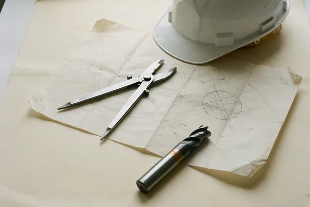 Illustration: Calipers, a drawing and a hard hat on the bench.