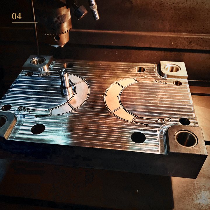 A machined steel mold plate on the machine bed under the spindle