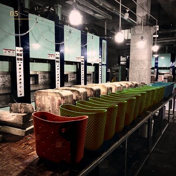 Molded plastic totes lined up as they come off the injection presses