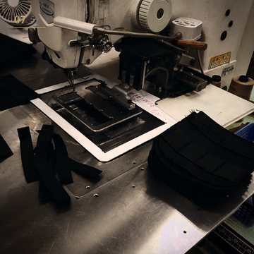 An industrial pattern sewing machine with cut fabric panels