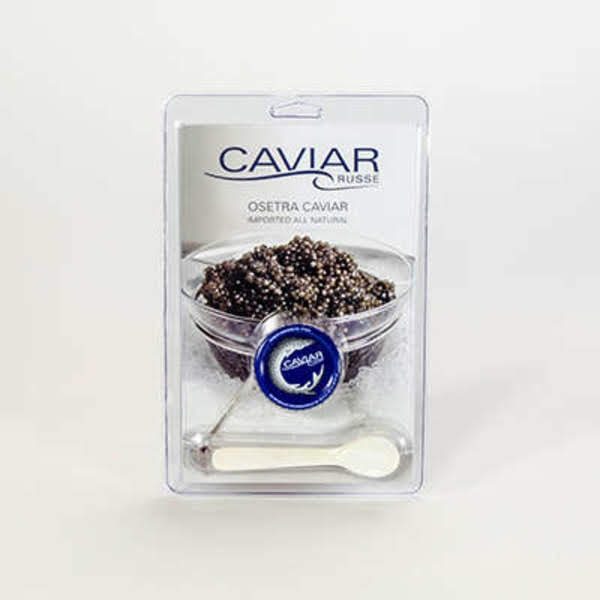 A clear hinged plastic clamshell holding a tin, a spoon and a printed insert card