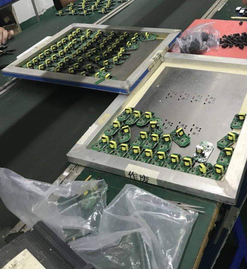 Trays of small circuit boards on an electronics assembly line