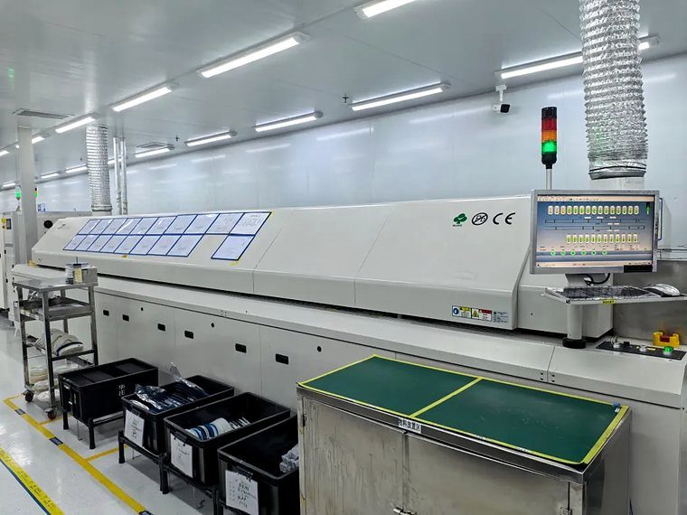 A reflow oven line in an electronics assembly hall