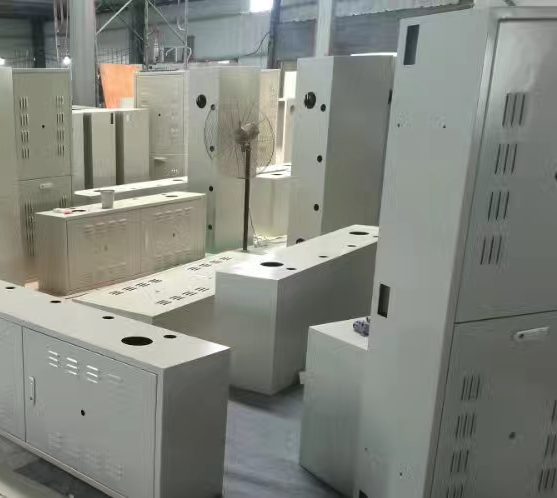 Fabricated sheet-metal electrical cabinets and enclosures standing in a workshop before wiring