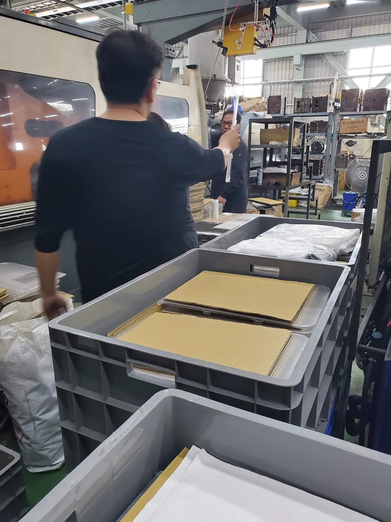 Parts being boxed at the end of a run, interleaved and stacked into returnable crates.