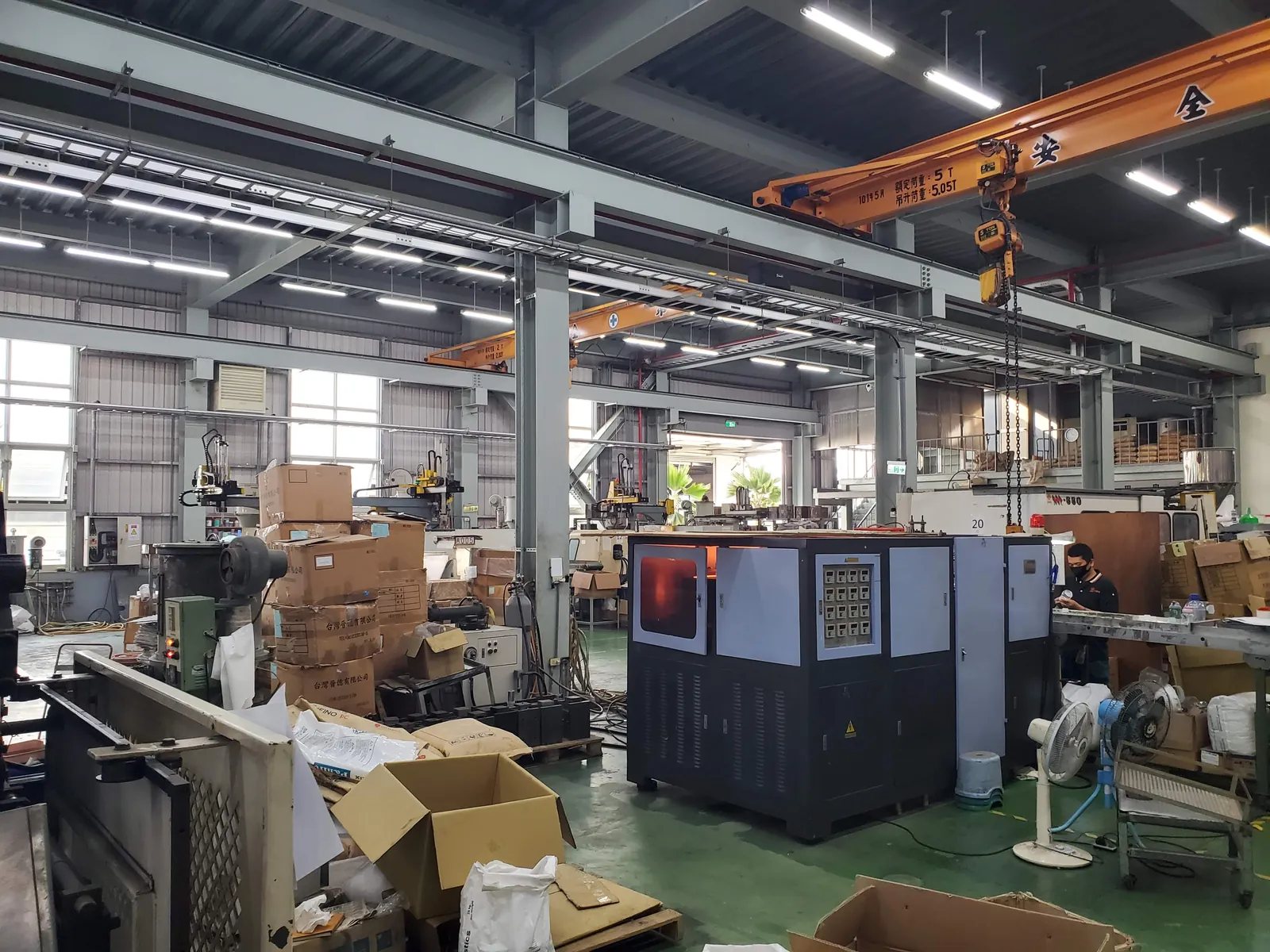 Overhead crane rail running the length of the shop. Tool changes on a mold this size are not manual.