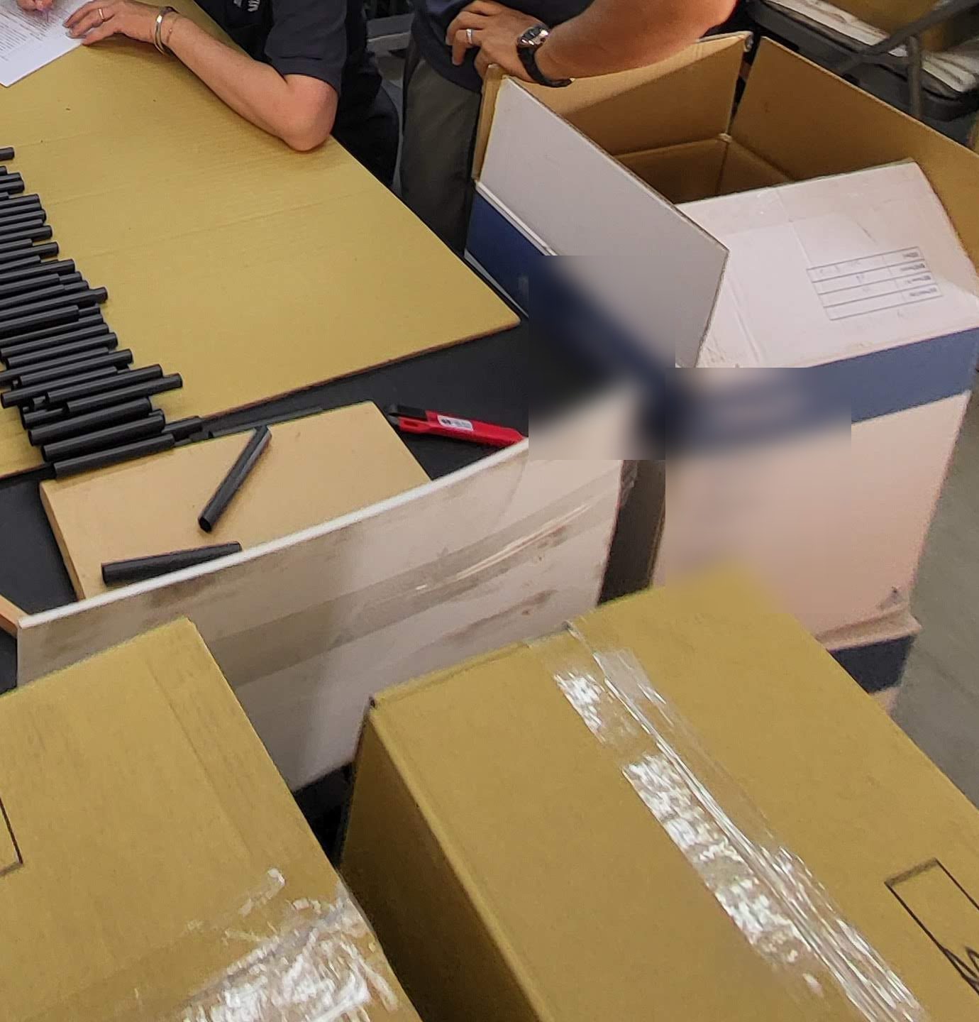 Packed units and cartons at the packing table.