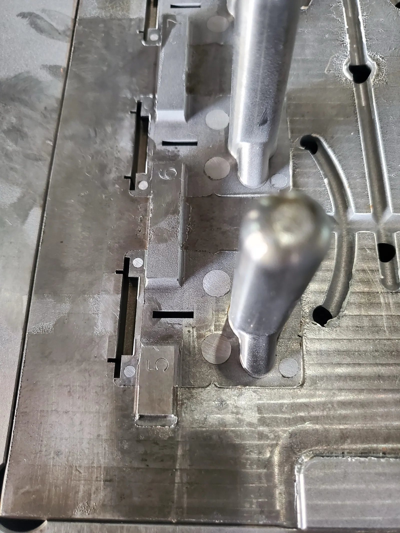 The same tool from the side. Slides and inserts are where a cheap quote and a real one diverge.