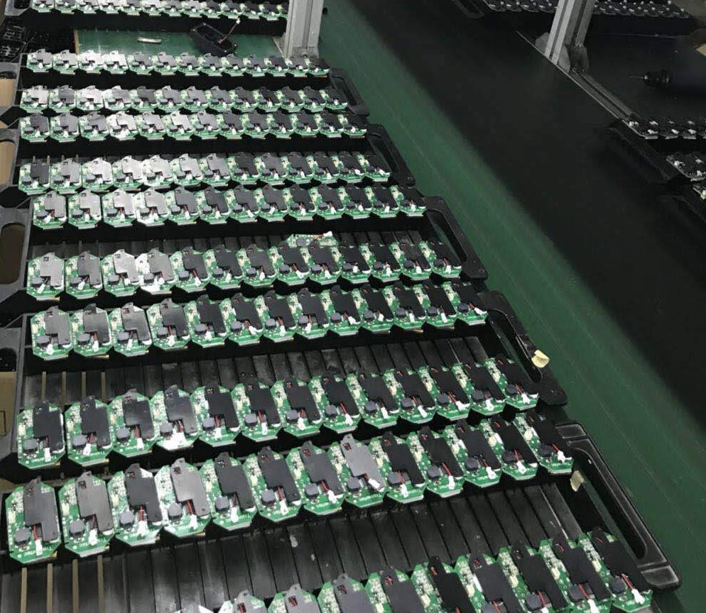 Rows of populated boards racked on a production line