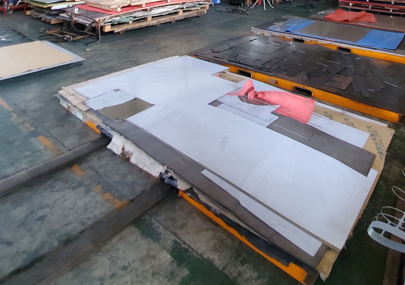 Sheet and plates staged on a shop-floor pallet