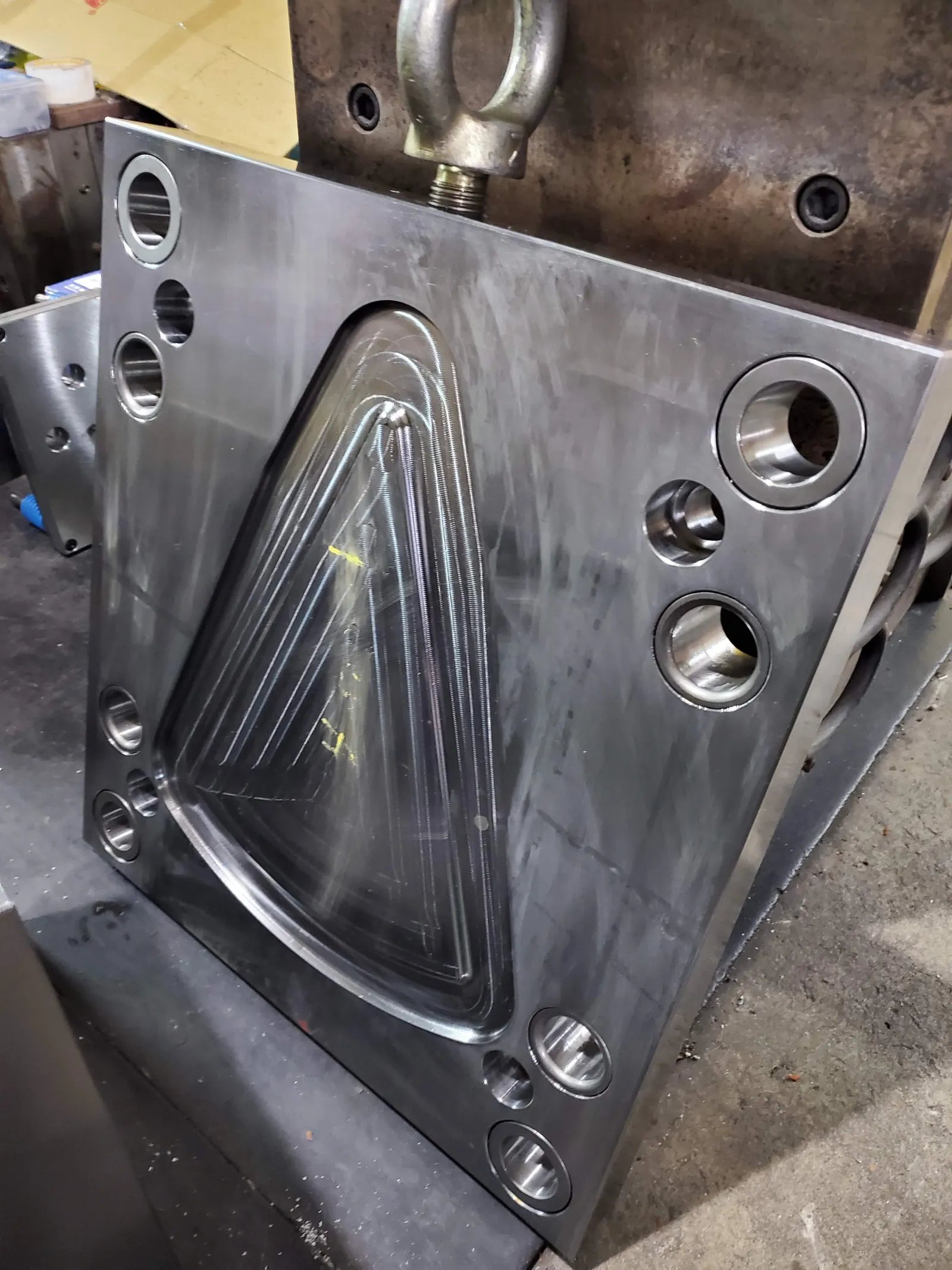 A polished cavity in a hardened tool block, with ejector bores and a machined runner.