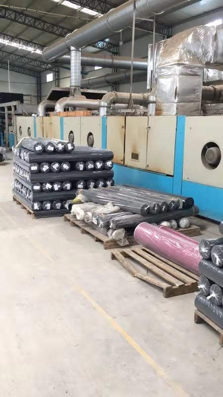 Rolls of finished fabric stacked in a mill