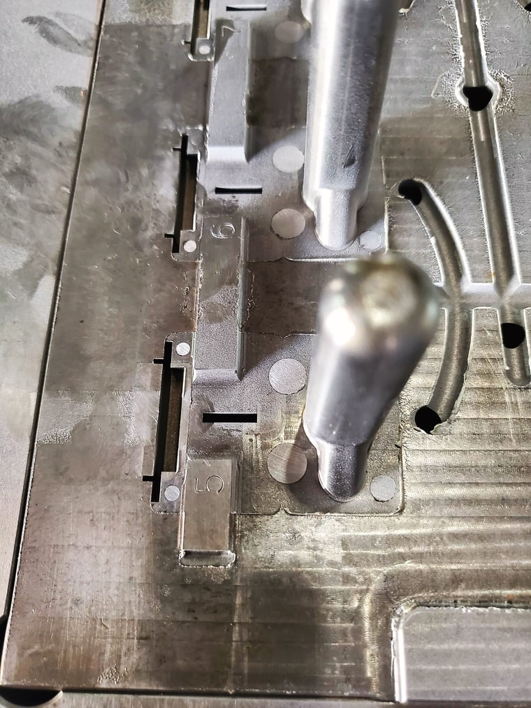 A mold core plate with core pins, close up