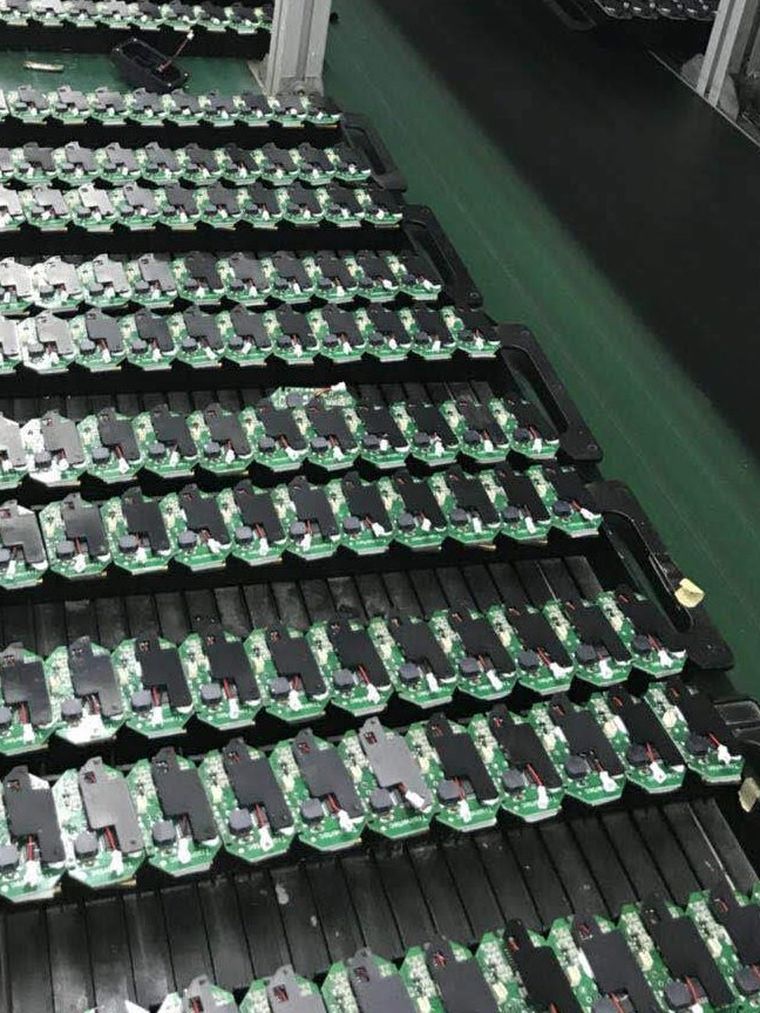 Rows of populated boards racked on a production line