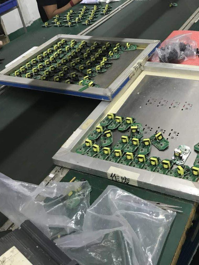 Small circuit boards laid out on steel stencil frames between operations