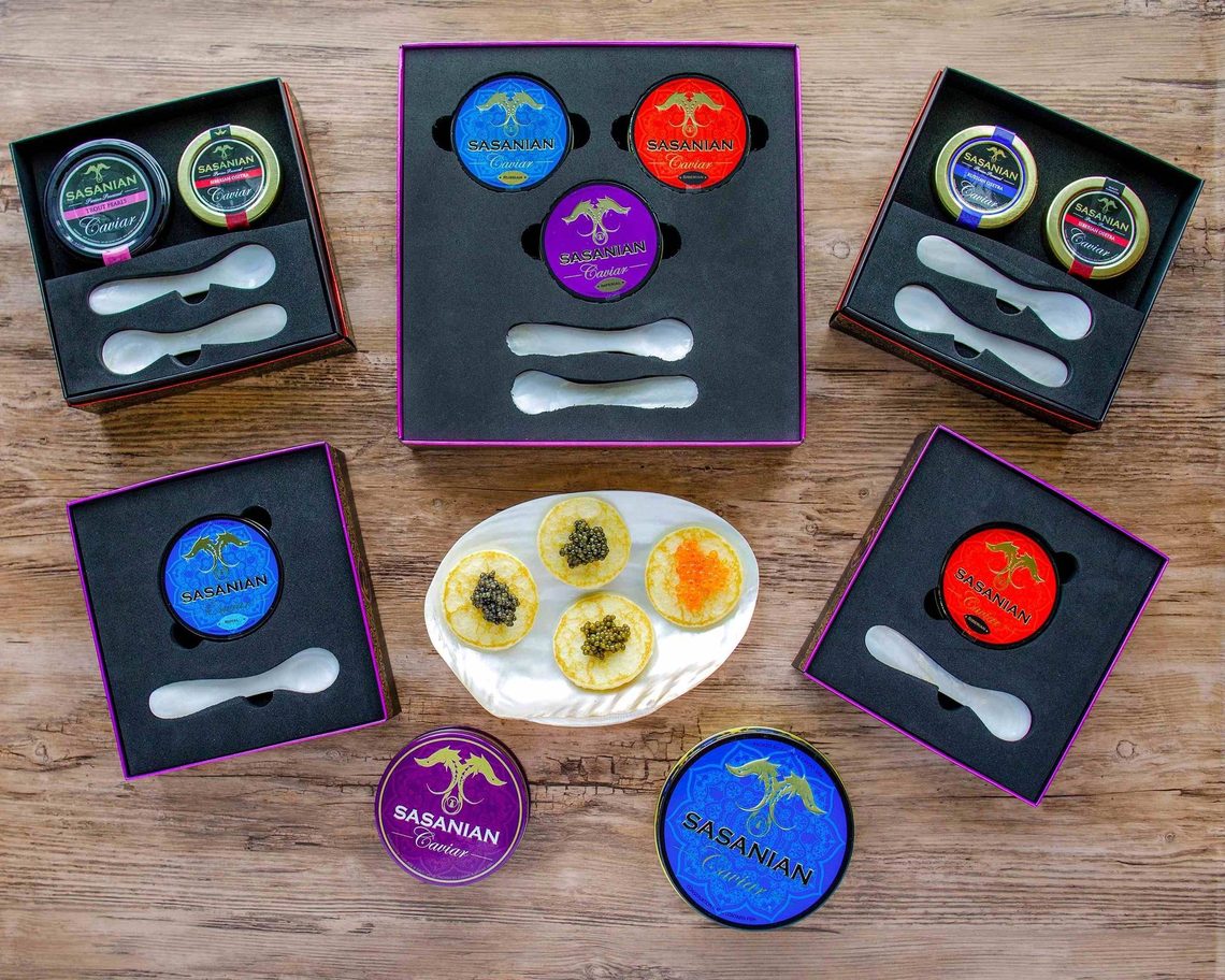 Printed caviar tins in fitted gift boxes with mother-of-pearl spoons