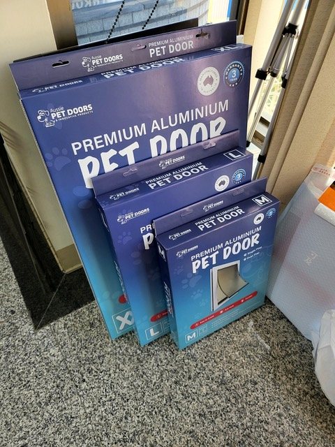 A range of printed pet door retail boxes in several sizes