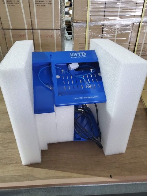 A boxed unit held in a foam insert inside a shipping carton