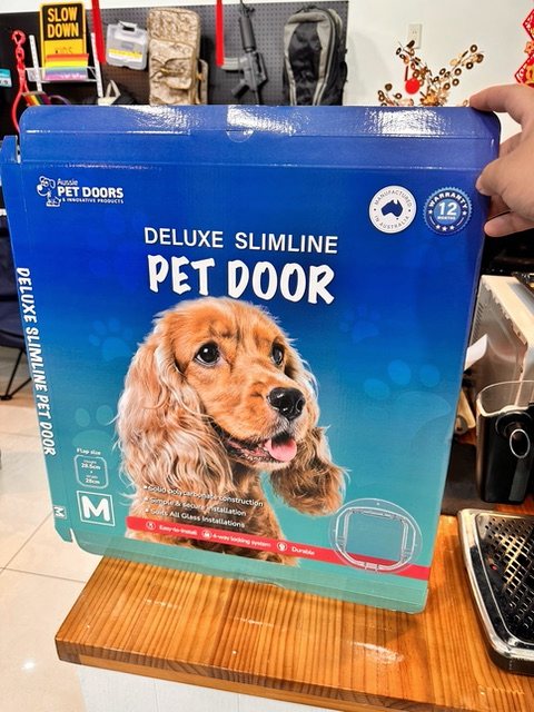 Deluxe Slimline Pet Door retail box with dog photography