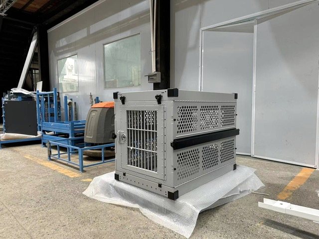 An aluminum crate finished and set on protective sheet.