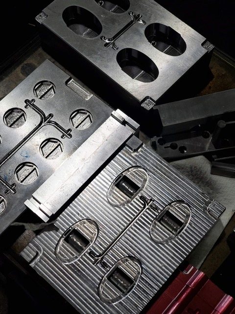 Mold plates and inserts laid out on the bench.