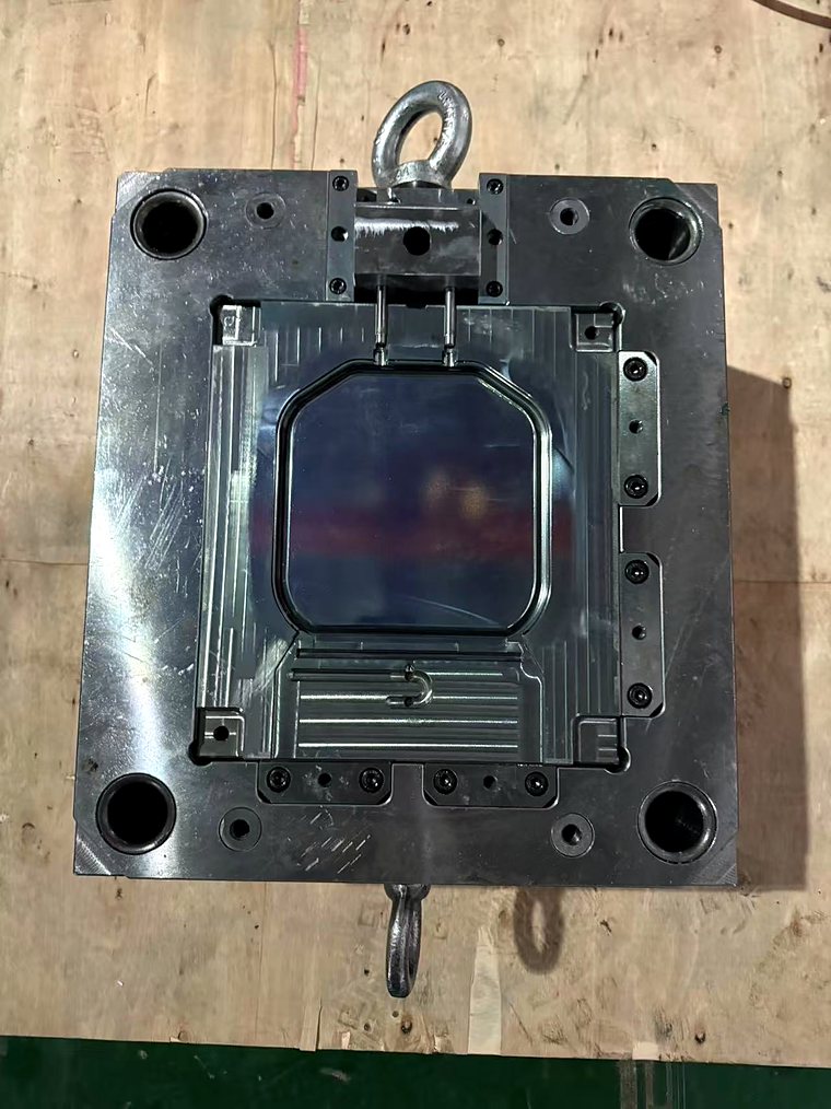 One half of an injection mold on the floor, cavity face up