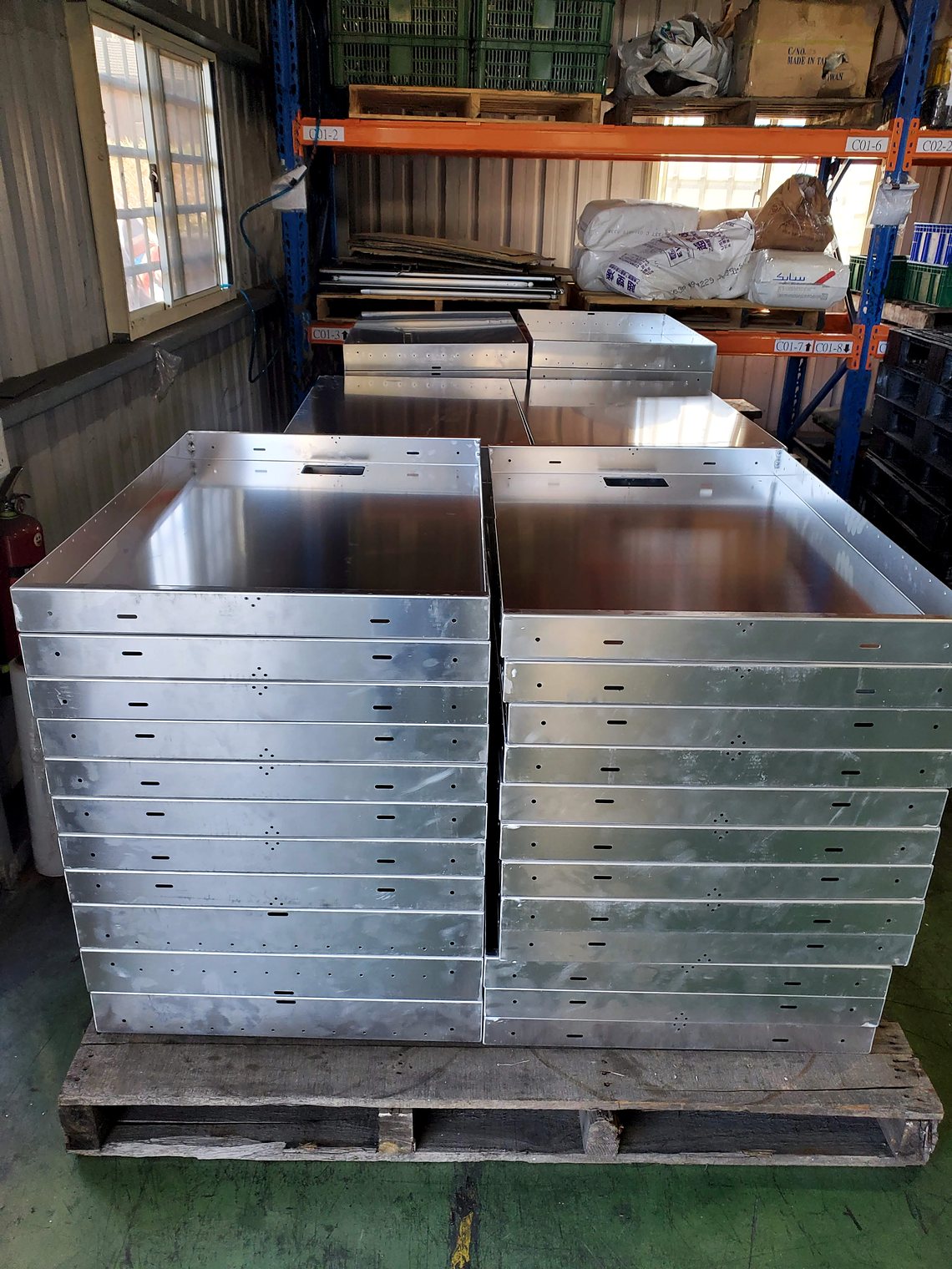 Formed stainless enclosures on a pallet.